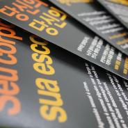 Fliers in multiple languages coloured black, orange and yellow